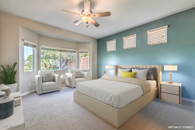 bedroom featuring light colored carpet and ceiling fan