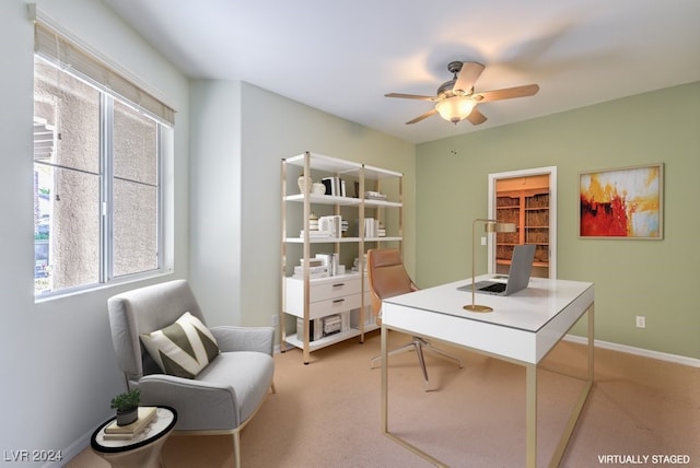 carpeted office space featuring ceiling fan