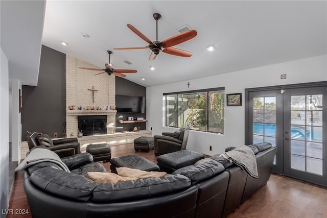 living room with ceiling fan, french doors, dark hardwood / wood-style flooring, high vaulted ceiling, and a fireplace