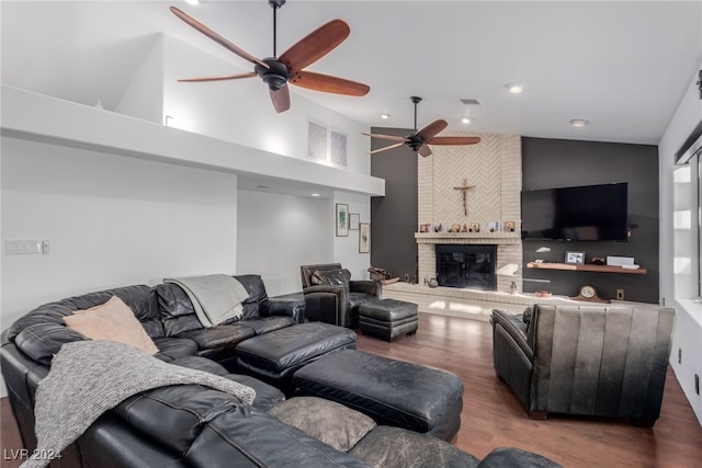 living room featuring high vaulted ceiling, a brick fireplace, ceiling fan, and dark wood-type flooring