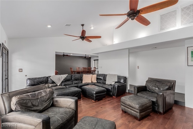 living room featuring dark hardwood / wood-style floors, high vaulted ceiling, and ceiling fan