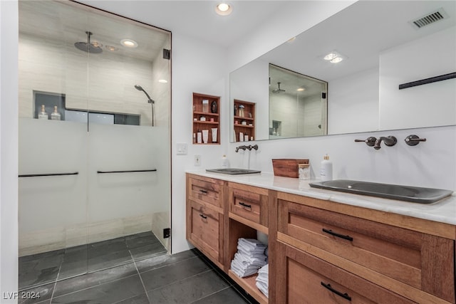 bathroom featuring tile patterned flooring, vanity, and walk in shower