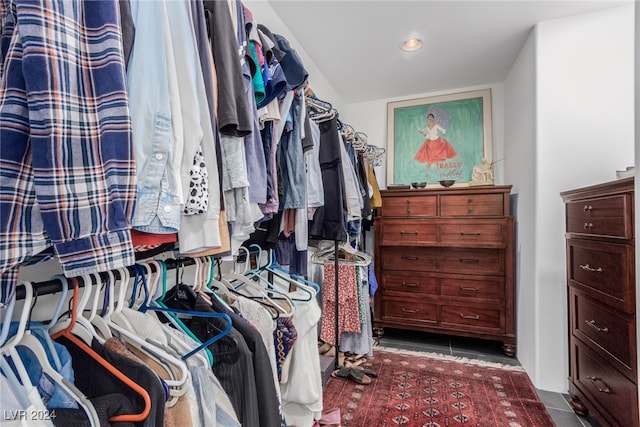 walk in closet featuring dark tile patterned flooring