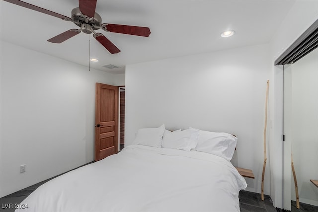 bedroom featuring dark carpet and ceiling fan