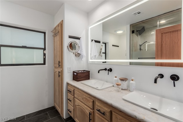 bathroom with tile patterned floors, vanity, and walk in shower