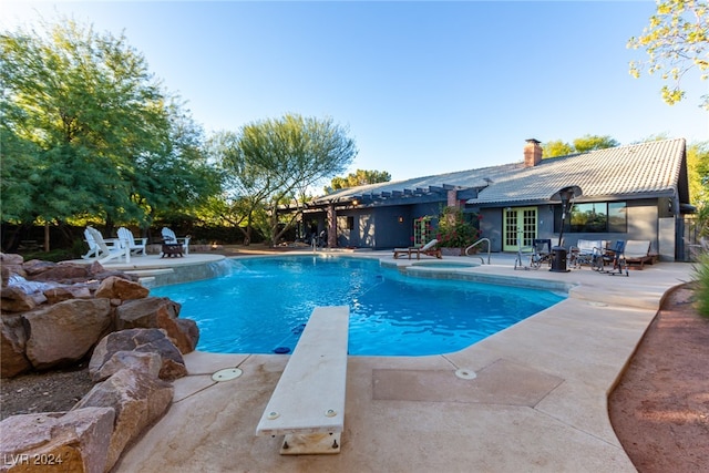 view of pool featuring a patio and a diving board