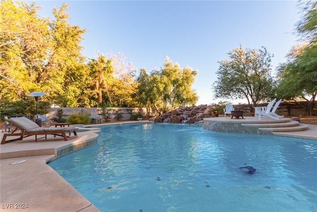 view of pool with pool water feature and a patio area