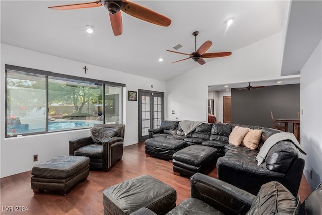 living room with hardwood / wood-style floors, lofted ceiling, and french doors