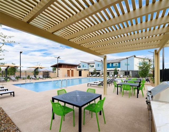 view of pool with a pergola and a patio area