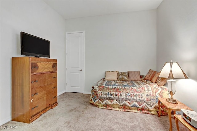 bedroom featuring light colored carpet