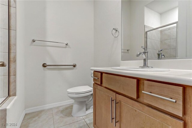 bathroom with vanity, walk in shower, tile patterned floors, and toilet