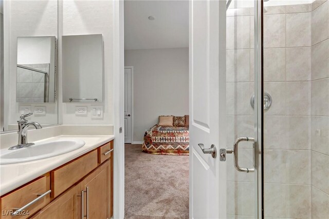 bathroom with vanity and a shower with shower door