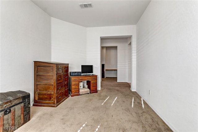 interior space with visible vents and light colored carpet