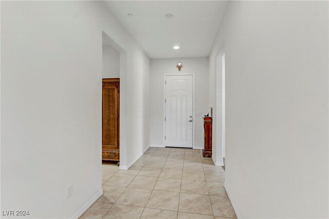 hall with light tile patterned floors