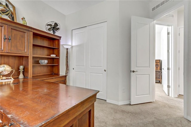 home office featuring light colored carpet, visible vents, and baseboards