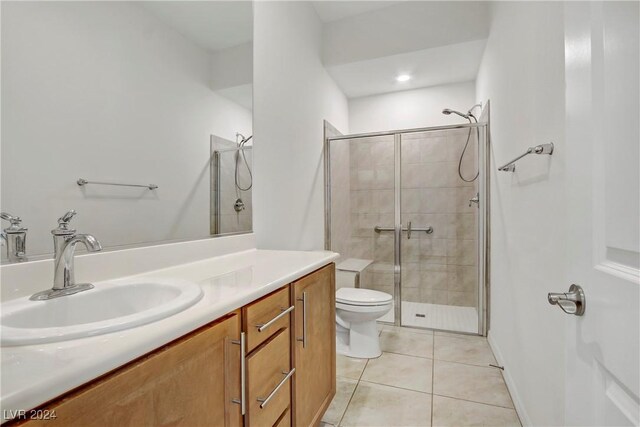 bathroom with tile patterned floors, toilet, an enclosed shower, and vanity