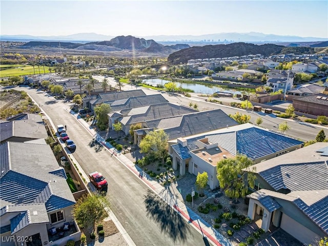 drone / aerial view featuring a water and mountain view