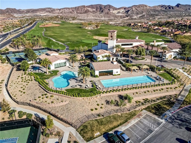 drone / aerial view featuring view of golf course and a mountain view