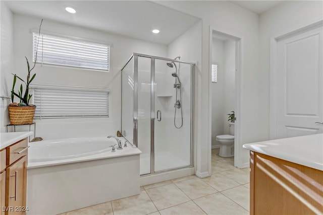 full bathroom with toilet, vanity, a bath, tile patterned floors, and a stall shower