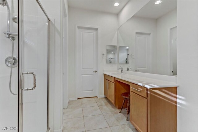 bathroom featuring vanity, an enclosed shower, and tile patterned flooring