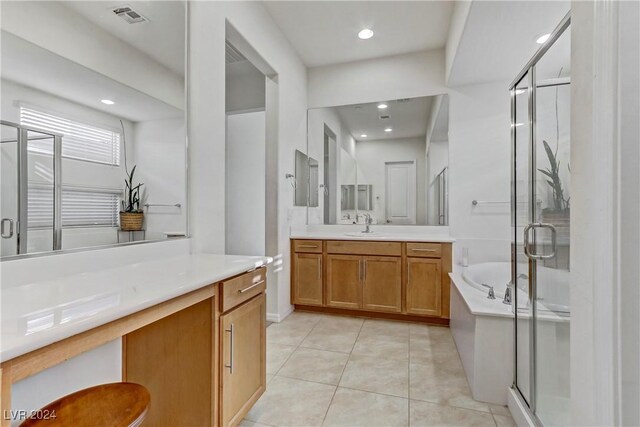 bathroom with tile patterned flooring, vanity, and independent shower and bath