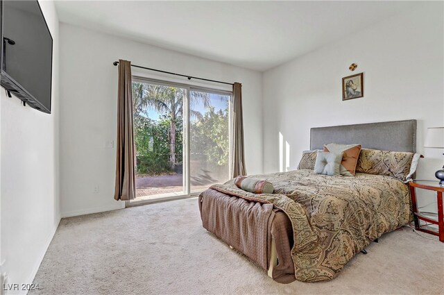 bedroom with light colored carpet and access to outside