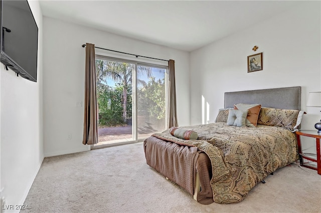 bedroom with access to exterior, baseboards, and light colored carpet