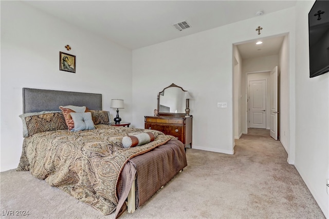 carpeted bedroom with visible vents and baseboards