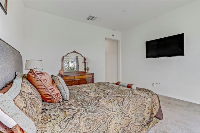 bedroom with carpet, visible vents, and baseboards