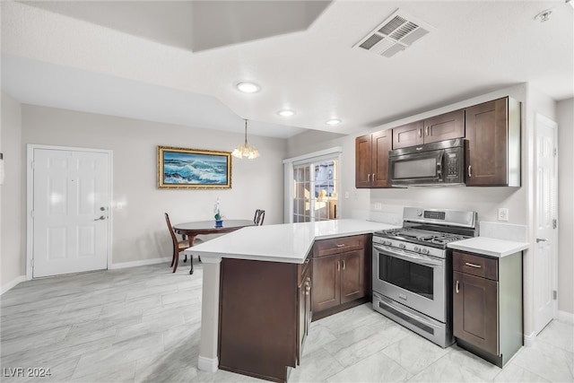 kitchen with kitchen peninsula, dark brown cabinets, stainless steel gas range oven, hanging light fixtures, and a chandelier