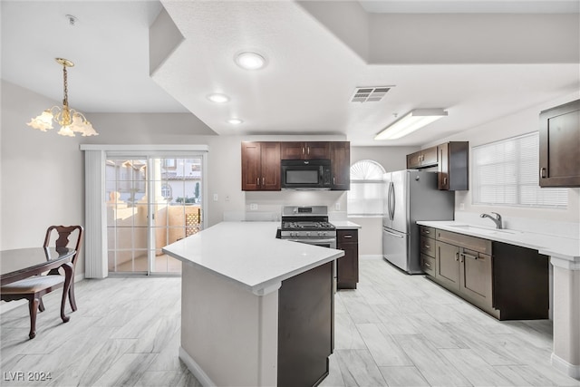 kitchen featuring stainless steel appliances, a notable chandelier, decorative light fixtures, and plenty of natural light