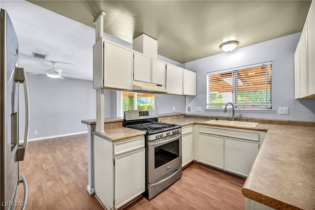 kitchen with white cabinetry, appliances with stainless steel finishes, sink, and plenty of natural light