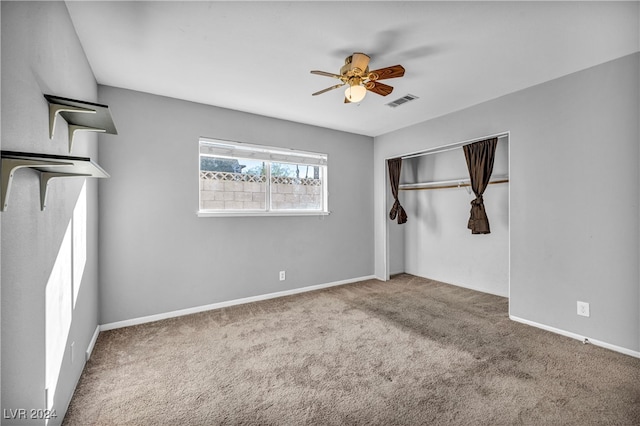 unfurnished bedroom with carpet flooring, ceiling fan, and a closet