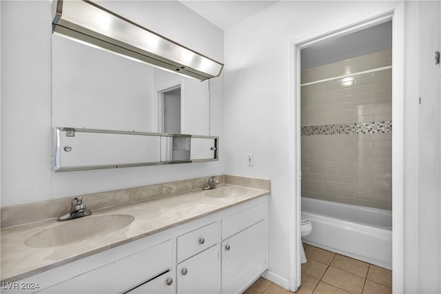 full bathroom with toilet, vanity, tiled shower / bath combo, and tile patterned floors