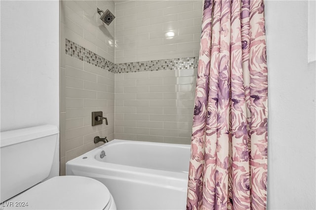 bathroom featuring shower / bathtub combination with curtain and toilet