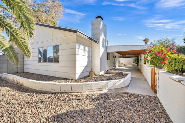 view of home's exterior with a carport