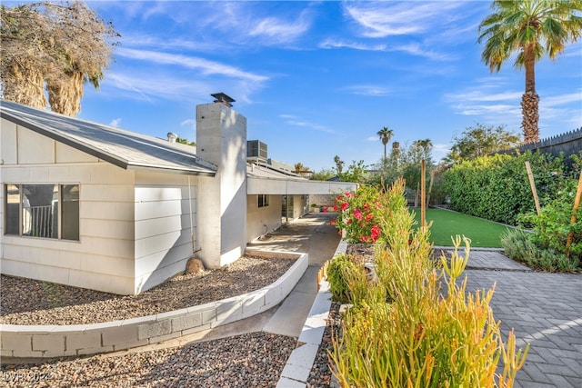 exterior space featuring a garage and cooling unit