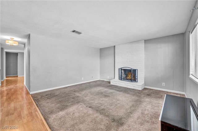 unfurnished living room featuring hardwood / wood-style floors and a fireplace