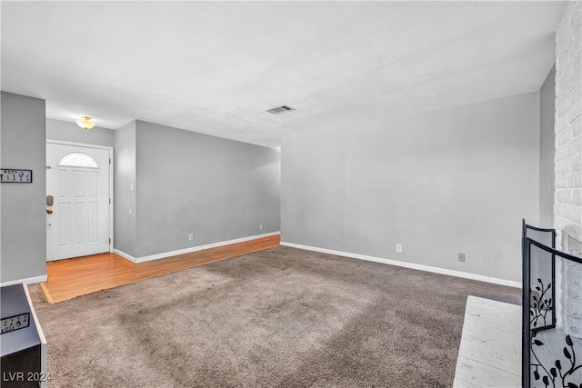 unfurnished living room featuring carpet and a fireplace