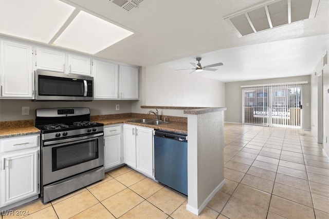 kitchen featuring white cabinets, sink, light tile patterned flooring, and stainless steel appliances