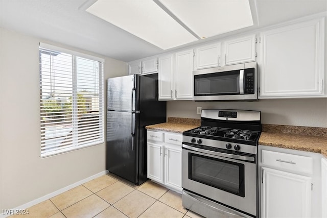 kitchen with white cabinetry, appliances with stainless steel finishes, and light tile patterned floors