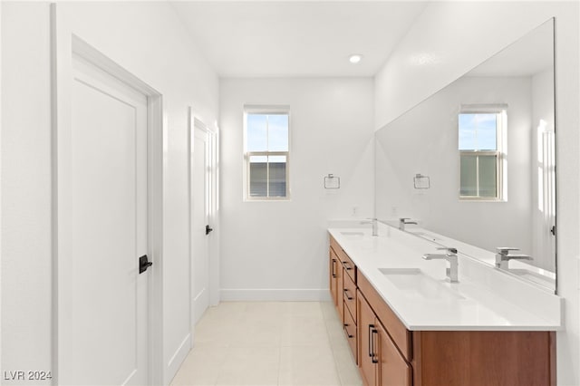 bathroom featuring vanity, tile patterned flooring, and a healthy amount of sunlight