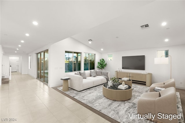 living room with vaulted ceiling and light tile patterned floors