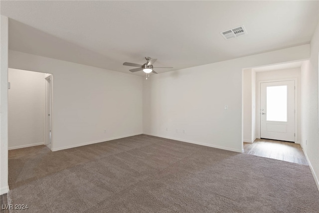 unfurnished room with light carpet and ceiling fan