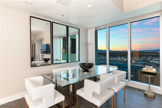 dining room featuring wood finished floors, visible vents, and baseboards