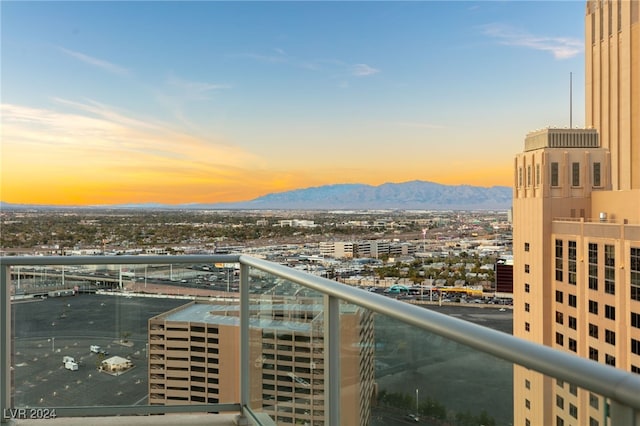 balcony with a mountain view and a city view