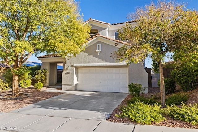 mediterranean / spanish-style house featuring a garage