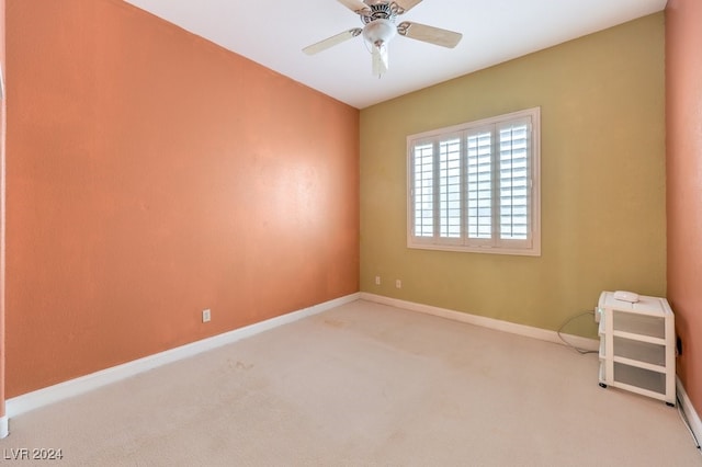 carpeted spare room with ceiling fan