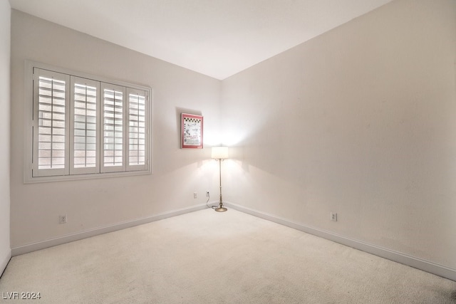 spare room featuring light colored carpet