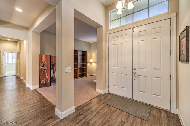 entryway featuring hardwood / wood-style flooring, a healthy amount of sunlight, and a chandelier